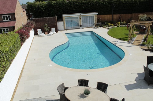 Beige Sawn Sandstone pool surround and paving from London Stone, laid by Timotay Landscapes