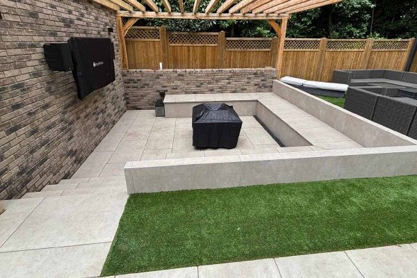 Almeria Beige Compact DesignClad used with very similar porcelain paving slabs, to clad rendered wall with steps leading to house.***JLM Garden Design, www.jlmgardendesign.co.uk
