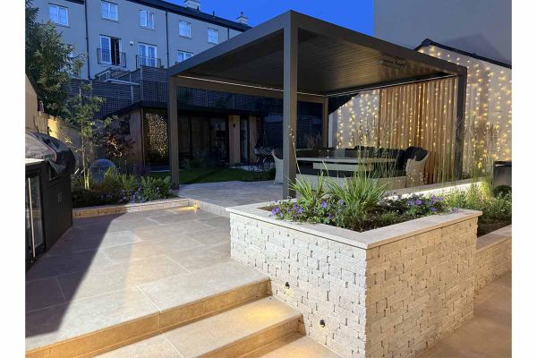 Antique Egyptian Beige limestone paving and wall copings in a modern garden with outdoor lighting and pergola***Eliza Gray Gardens & Minerva Landscaping

