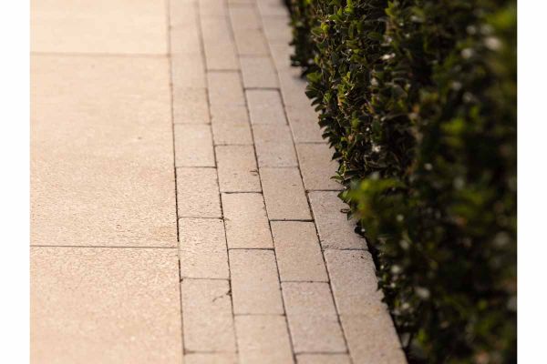 Antique Egyptian Beige Limestone Pavers arranged in a square-laying pattern, emphasizing the textured surface and natural weathered appearance.***Image for illustrative purposes only, not installation guidance

