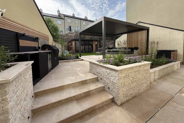 Antique Egyptian Beige limestone steps leading to elevated outdoor space in a landscaped garden by Eliza Gray Gardens***Eliza Gray Gardens & Minerva Landscaping
