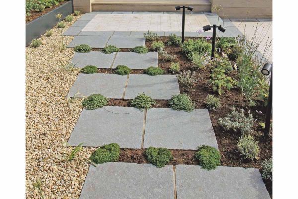 Close-up shot emphasising the rustic elegance and unique character of Antique Grey Limestone paving.***
