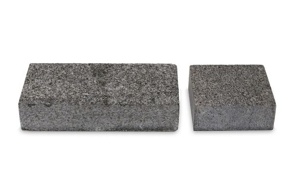 Professional photography showcasing one 200x100 and one 100x100 Sawn Black Granite sett next to each other on a white background.***