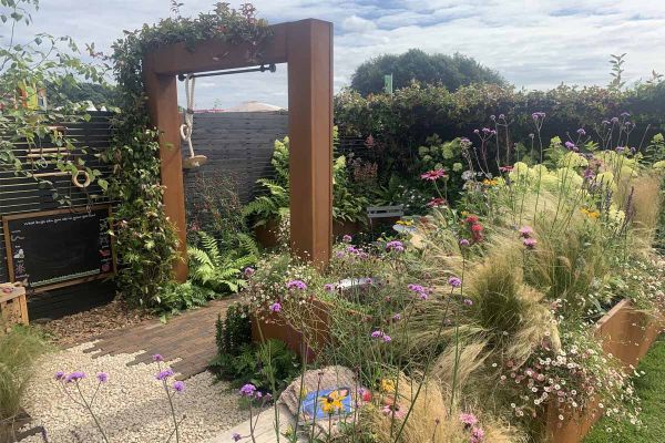 A garden featuring Derby Clay Pavers, lush plants, and corten steel elements, awarded Silver Gilt at RHS Tatton Park 2024.***Evergreen Cheshire Ltd, www.evergreencheshireltd.co.uk | RHS Tatton Park Flower Show 2024 Silver Gilt medal winner