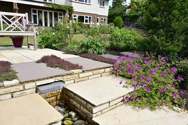 Design by Painted Fern, mint sandstone garden walling creates water feature paired with matching paving.***Designed by Painted Fern Garden Design www.paintedfern.co.uk | Built by Sustainable Landscapes, www.sustainablelandscapes.uk
