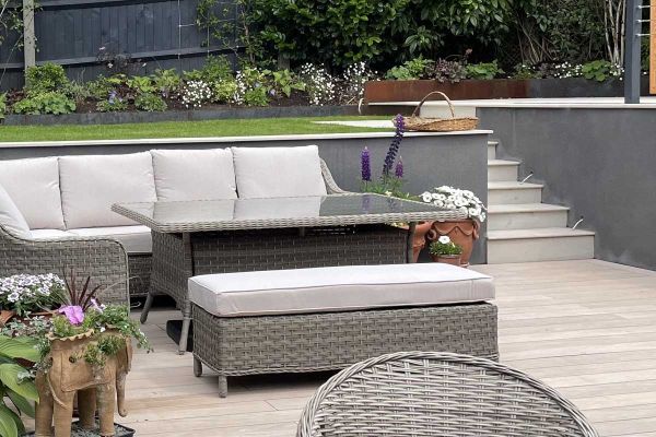 Steps leading away from decking area made from Faro Porcelain, have 20mm Bullnose edge and go up to lawn with bordering plants.***Design by Wilson Associates Garden Design, www.wilsongardendesign.co.uk | Built by JG Landscaping, www.jglandscapinguk.com