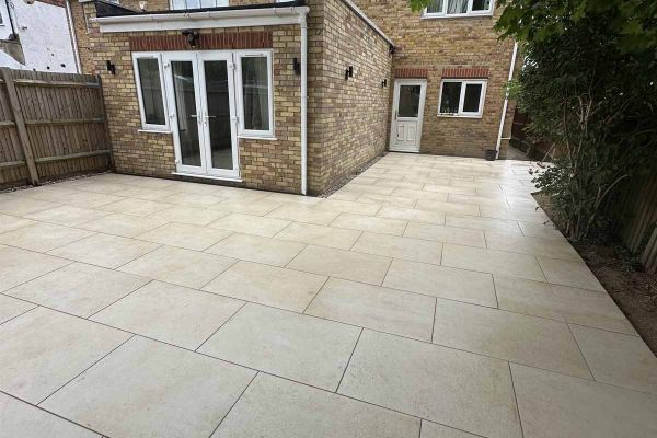 Single Sawn Sandstone porcelain paving slab, viewed from above, showing texture and markings including imitation stone surface.***
