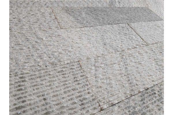 Close-up of Pearl Grey Granite Cladding surface showing its speckled grey tones and fine ridges.***
