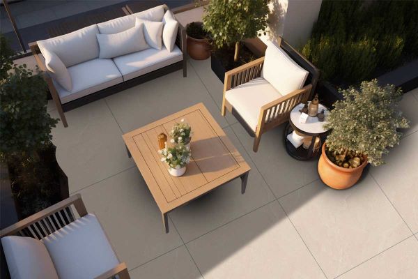 Stylish outdoor terrace using Piazza Beige tiles, with white garden furniture and decorative planting.***
