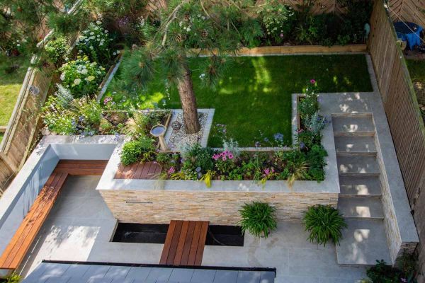 Birds eye of multi level garden with raised planters and walls, coping stones in silver grey with pencil round edges.***Hythe Garden Landscapes Ltd, www.hythegardenlandscapes.co.uk
