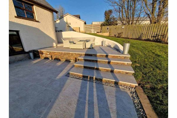 Steps leading to a house from a patio, made of Silver Grey Porcelain, with 3 40mm Downstand Steps heading to dining area.***Dan Jury Building & Landscaping, www.facebook.com/Danjurybuilding