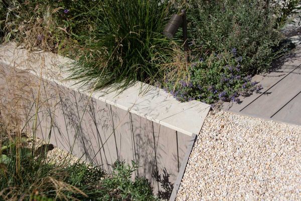 Close up of raised wall clad with composite material, slab khaki porcelain used for wall coping with 5mm pencil round profile.***Doug Holloway Garden & Landscape Design, www.dougholloway.co.uk