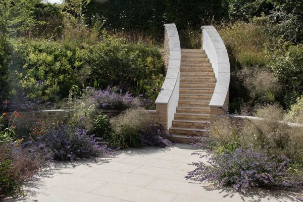 Staircase using golden stone porcelain 5mm pencil round steps, leads up through wildlife away from patio surrounded by lavender and wild flowers***Doug Holloway Garden & Landscape Design, www.dougholloway.co.uk