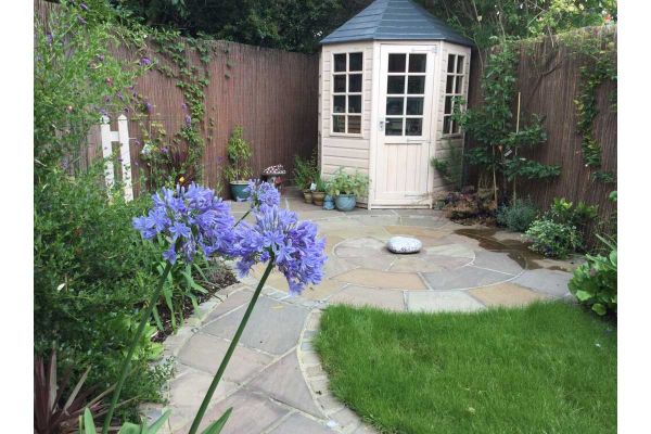 Path edged with Autumn Brown sandstone setts leads to paving circle and white octagonal summer house. Design by Floral and Hardy.***Floral & Hardy Groundworks Ltd, www.floralandhardy.co.uk
