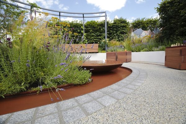 2 rows of sawn silver grey granite setts create edge between resin-bonded gravel and curved pond with water bowl and planting.***Designed by Aleksandra Bartczak | Built by David Jarvis Associates
