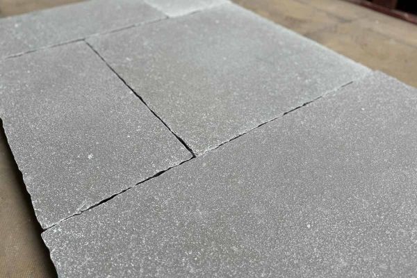 Close-up shot emphasising the rustic elegance and unique character of Antique Grey Limestone paving.***
