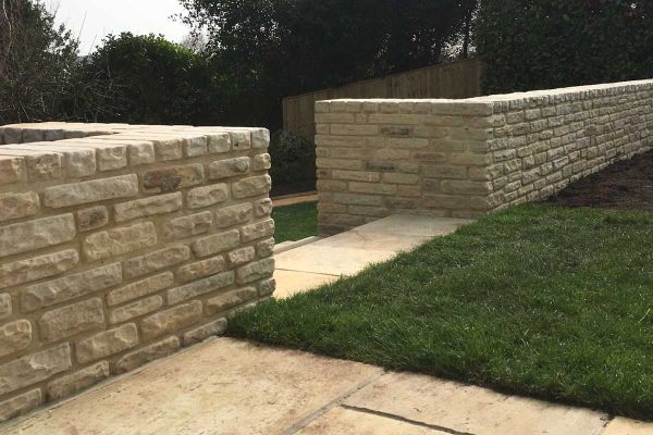 2 Mint sandstone walls edge lawn of paved area. and meet at gap, turning right angles to create flanking walls to steps.***Brambletye Landscapes,  www.brambletye.land