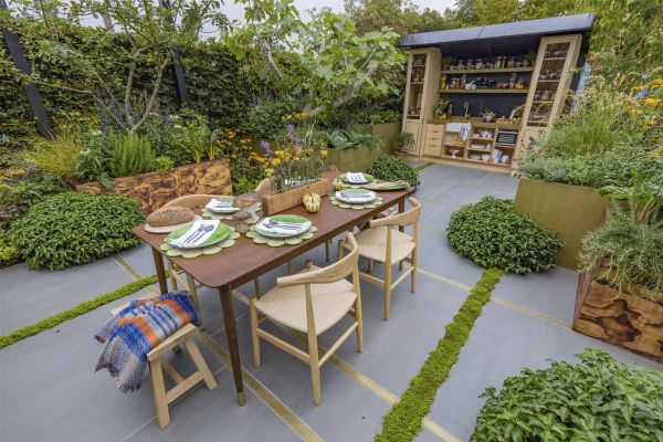 Large Format Porcelain Paving with strips of grass laid in between and heavily planted raised flower beds.***Design by Alan Williams | Built by Landform Consultants, www.landformconsultants.co.uk