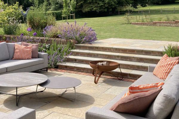 4 Antique Yellow limestone outdoor steps descend from lawn to matching patio with firebowl. Built by Simon Scott Landscaping.***Designed by Bo Cook Landscape & Garden Design, www.bocook.co.uk | Built by Simon Scott Landscaping, www.simonscottlandscaping.c