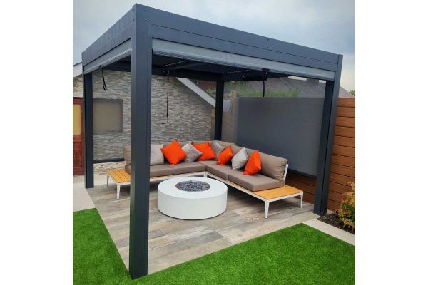 Garden furniture under grey pergola on Honey wood effect porcelain paving slabs. Designed by Stonecraft of Lancashire.***Image also displays Faro Paving & Dark Grey Pergola | Stonecraft Of Lancashire Ltd, www.stonecraftltd.co.uk