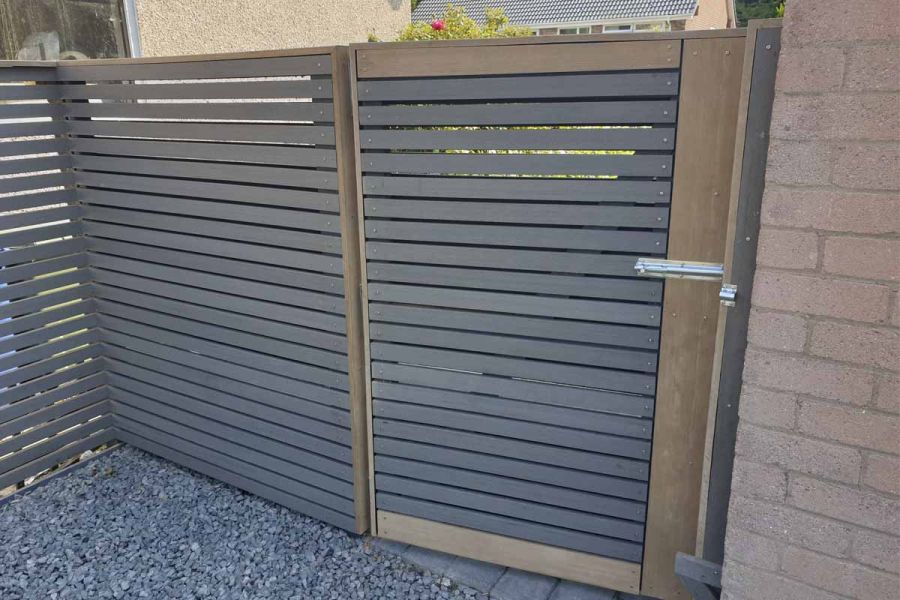 Garden fence and gate of matching height, made by 3D garden design, of Pebble grey composite battens with long steel bolt fastening.