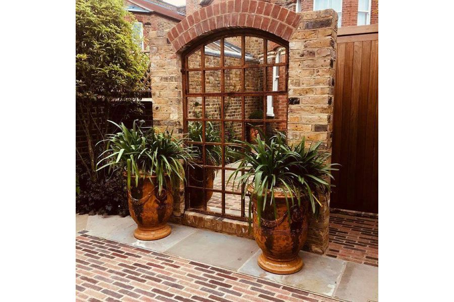 Seville mixed with Abbey Dark Multi Clay Pavers in front of urns and trompe l’oeil mirrored gate in brick wall.