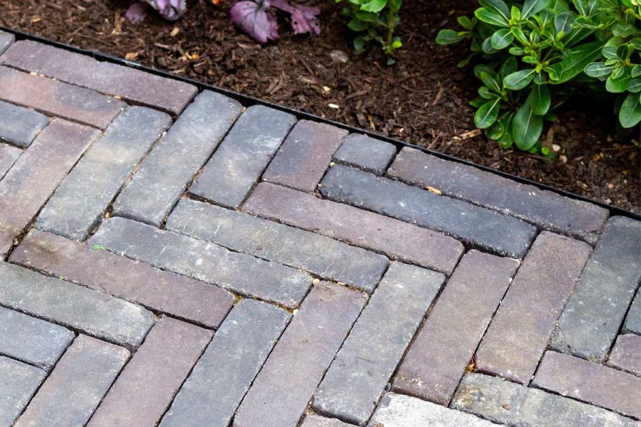 Ancona clay pavers laid in herringbone pattern next to metal-edged mulched border. Built by Acacia Gardens. Design by Daniel Shea.