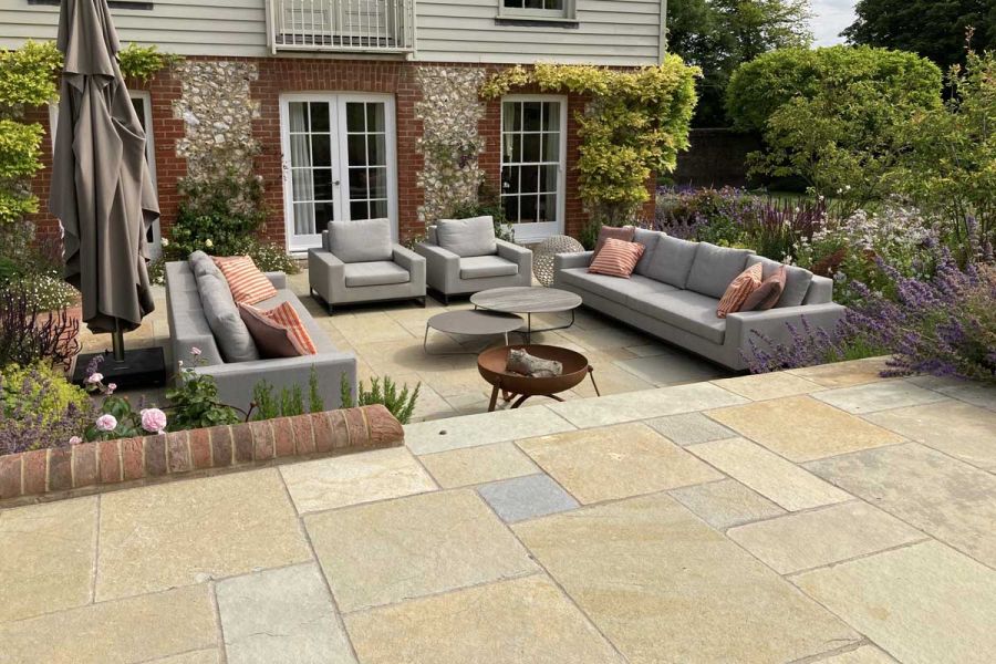 Patio, on 2 levels, of Antique Yellow limestone tumbled slabs in mixed sizes, designed by Bo Cook Landscape and Garden Design