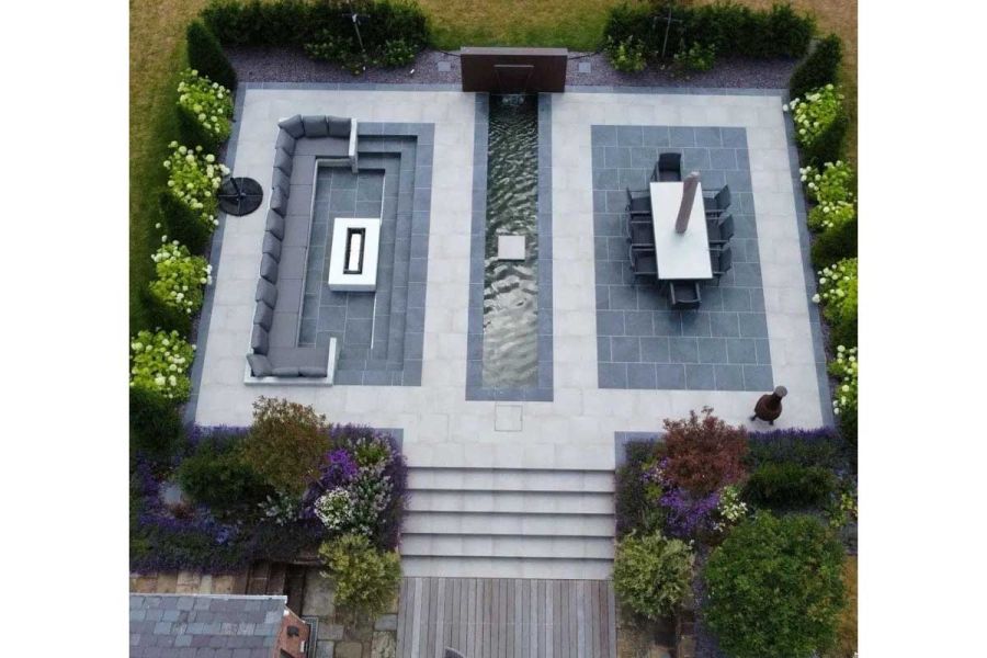 Aerial view of Cement porcelain steps up to seating and dining areas either side of long pond. Design by Bancroft Lee Landscaping.