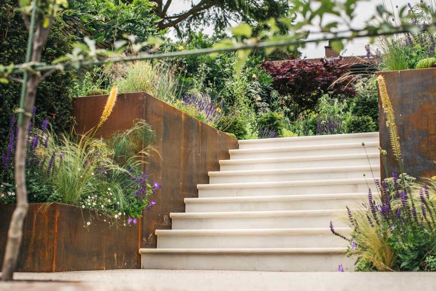 Flight of Beige Sandstone Bullnose step treads and matching risers between Corten Steel planters. Design by Artisan Landscapes.
