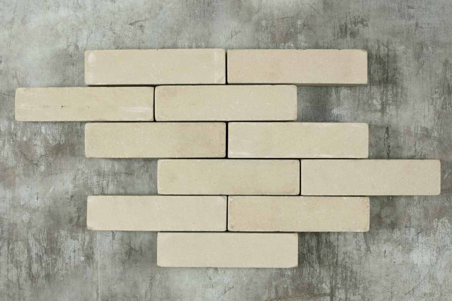 11 Beige sandstone patio bricks laid in 6 rows of 1 or 2 pavers on a dark background. Free UK delivery available.