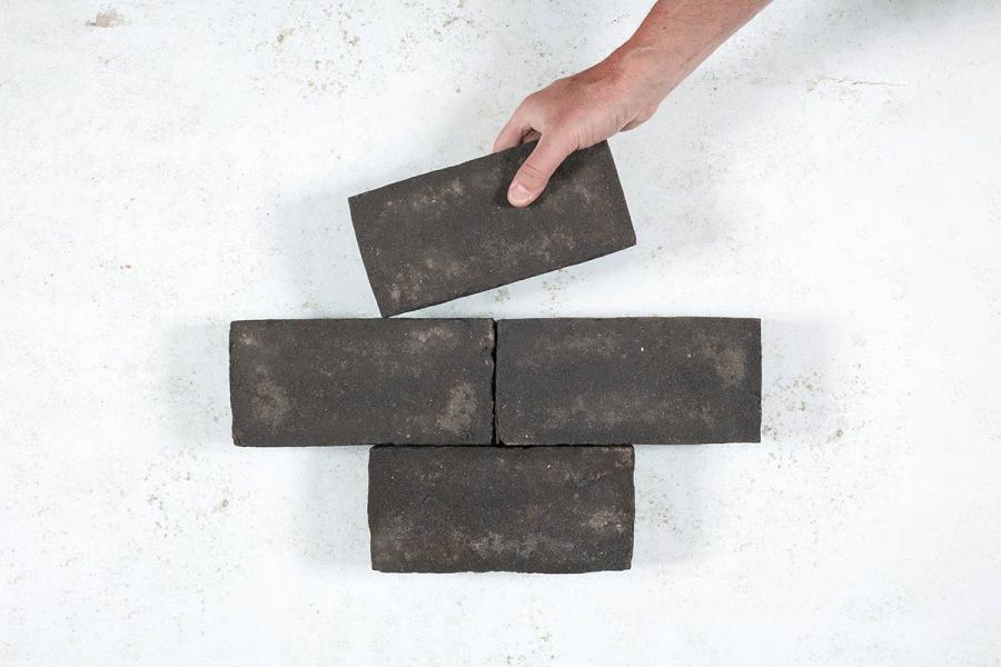 Hand places single Durham Clay Paver into formation of 3 other bricks arranged in rows of 1 and 2. Free UK delivery available.