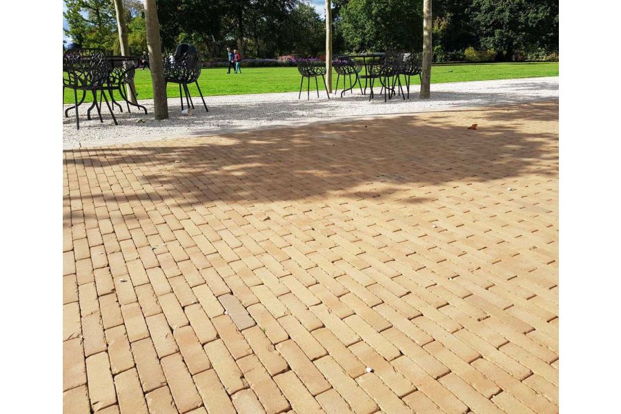 Large public lawn separated from Westminster brick paved area by gravel strip with chairs and tables. Built by Blakedown Landscapes.