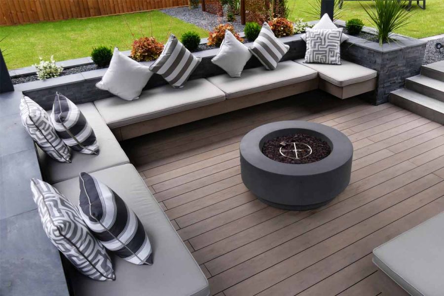 Brazilian black slate coping stones top walls that line sunken seating area paved with Traditional DesignBoard composite decking.