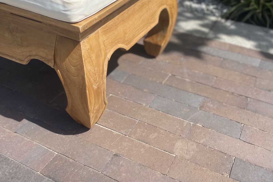 Bandy-legged footstool on Chelsea Dutch clay paving laid running bond with sanded joints at BBC Gardeners 