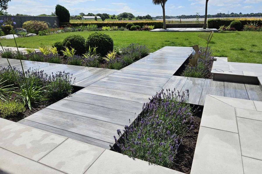 impressive views of the countryside with path of cinder porcelain paving leading towards large lawn area, surrounded by lavender.