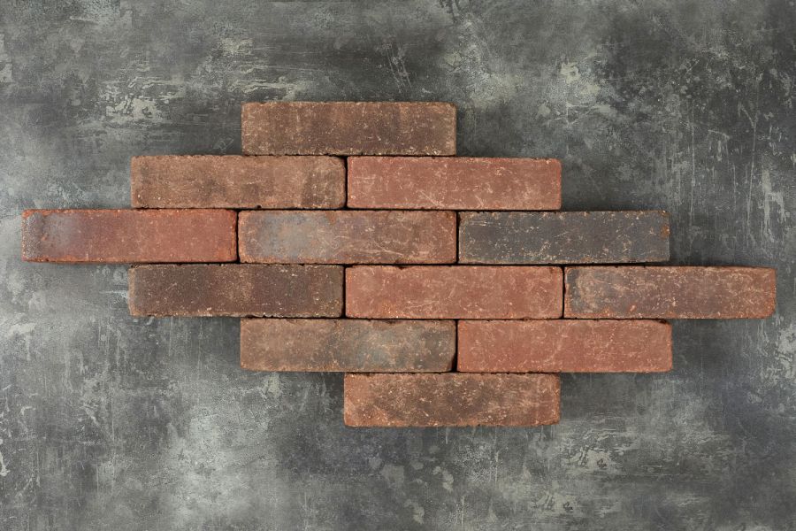 12 Antique Red brick pavers laid in 6 rows of varying lengths on a dark background. Free UK delivery available.