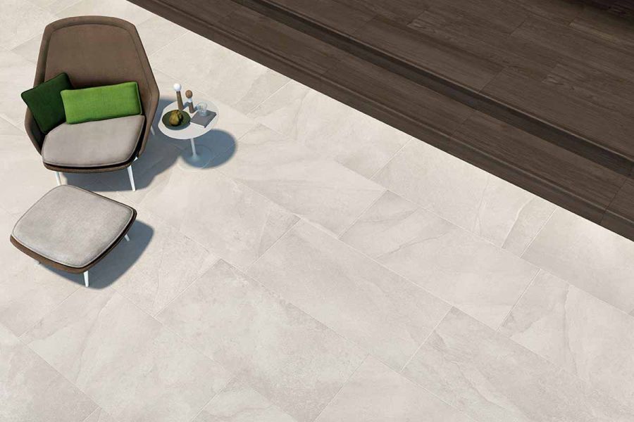 Comblanchien patio tiles photographed from above, featuring coffee table with armchair available exclusively from London Stone.