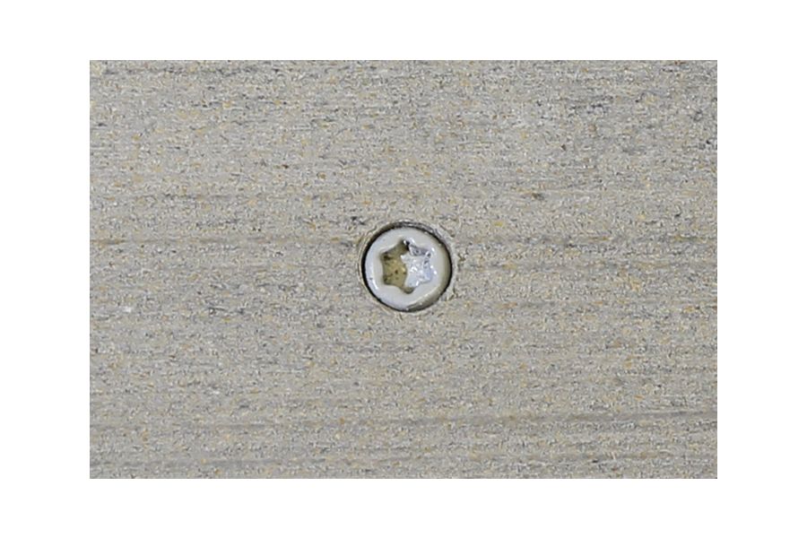 Luna composite decking board with Luna colour match screw fixed to the middle of the board. 