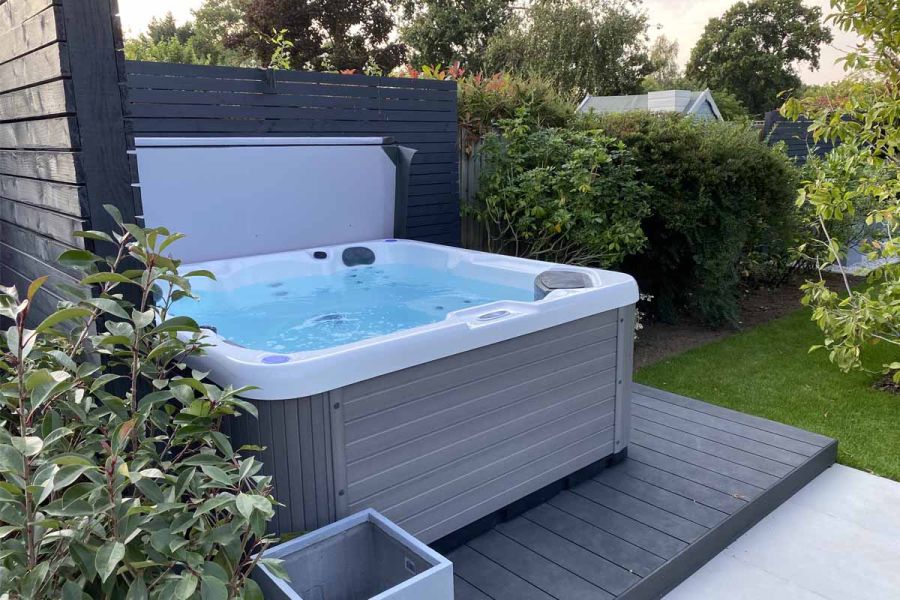 Water bubbles in grey and white hot tub on Dark Ash Brushed DesignBoard garden decking, Design and build by Limebok Landscaping.