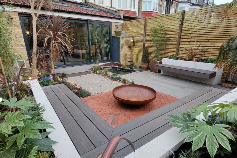 Delta light Multi Clay Pavers contrast with grey porcelain planks in seating area of small garden. Design by Floral and Hardy.