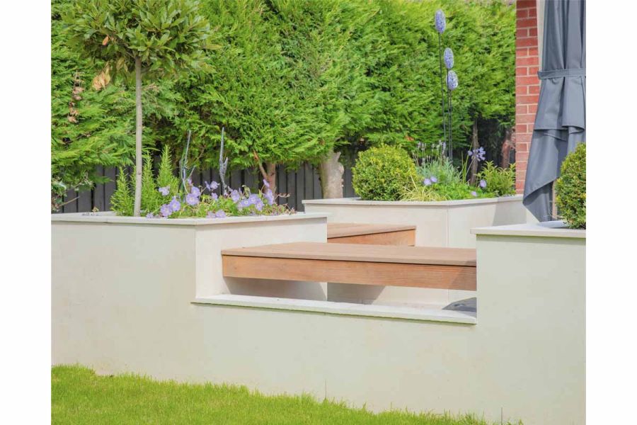 Wooden benches link rectilinear raised beds faced in Desert Beige exterior cladding from our Premium DesignClad range.