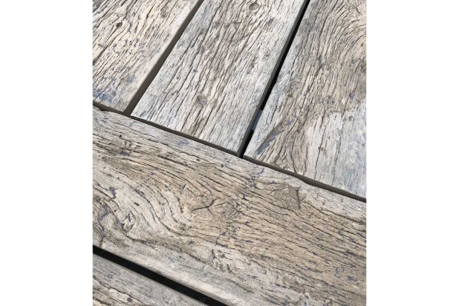 Close up of Driftwood Millboard decking, with 3 planks laid at right angles to 2 more. 