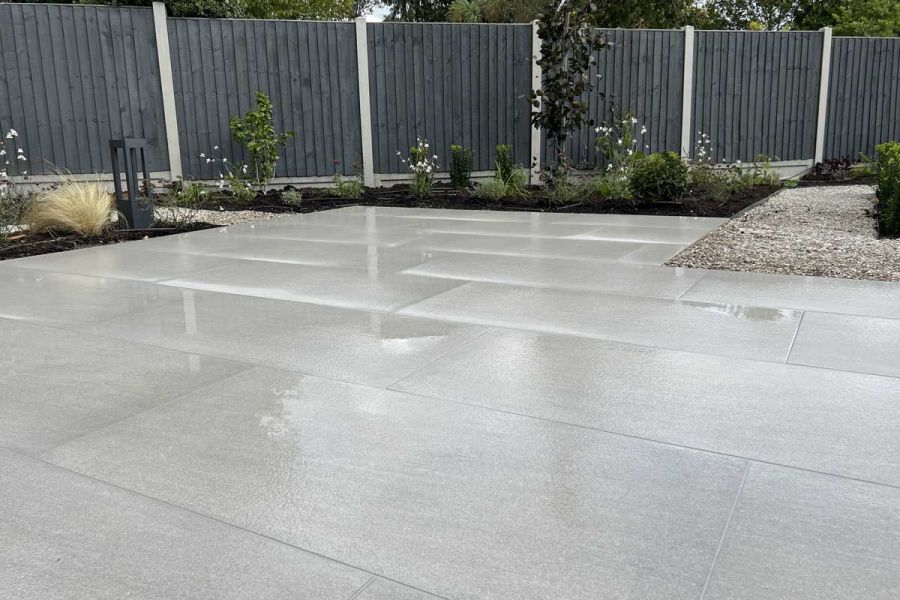 close up shot of urban grey porcelain paving showing its texture in wet weather. Design and build by Essex Garden Co