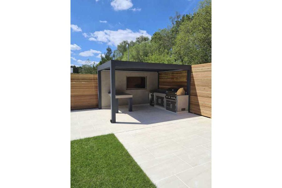 Faro Porcelain with Deponti Pinela Deluxe metal pergola with louvered roof and red cedar slatted fence panels from London Stone.