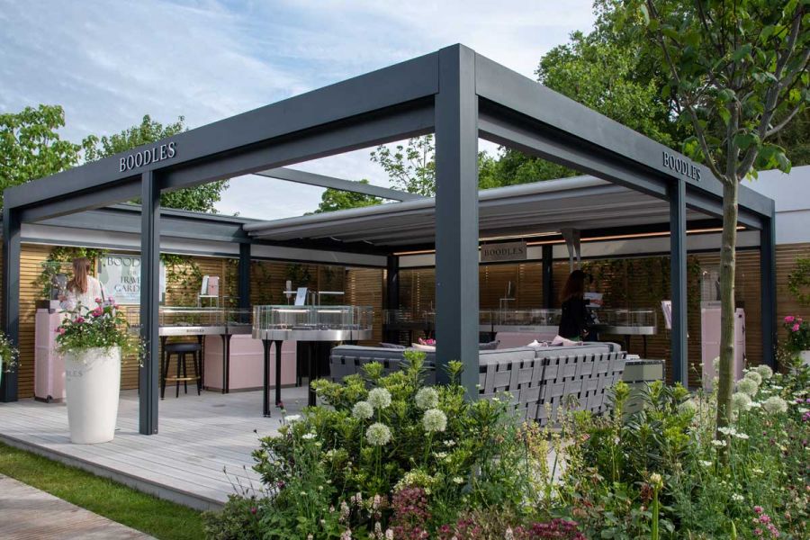 Large pergola covers RHS Chelsea trade stand laid with Luna composite decking boards edged with matching pencil round boards.
