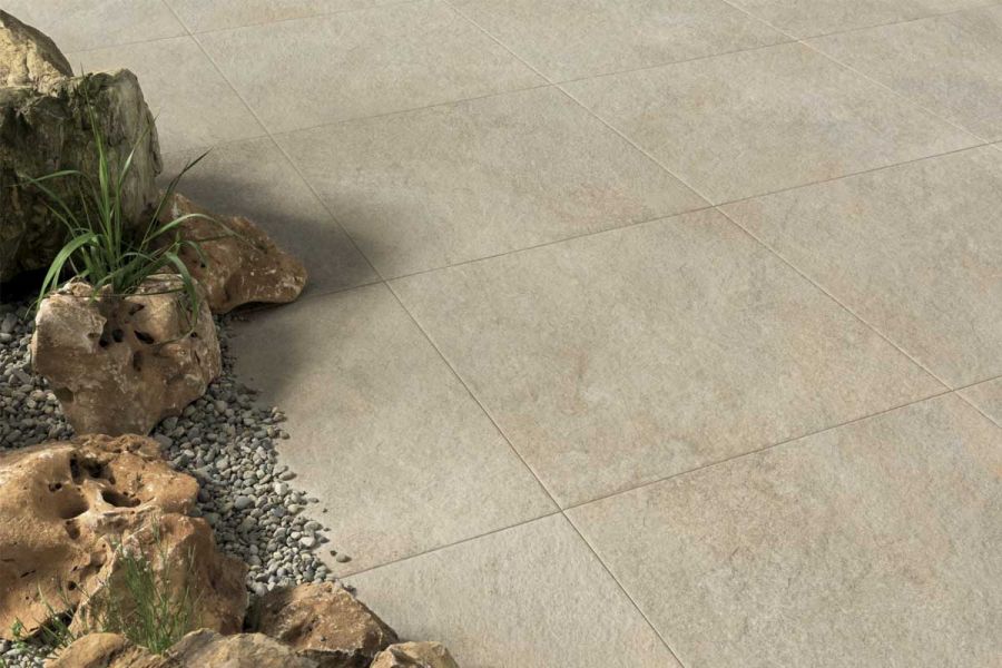 Gea vitrified porcelain paving slabs photographed from close proximity, featuring boulders and pebbles in the left-hand side.