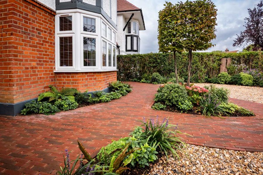Front garden laid to gravel and Winton brick pavers. Low planting and pleached trees in beds and borders. Design by Georgia Lindsay.