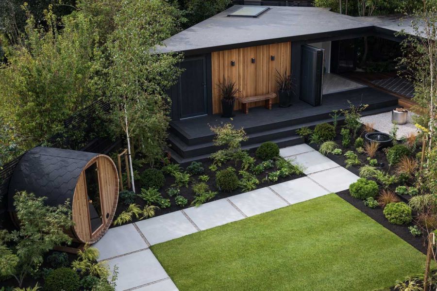 Birds eye view of Yard 1200x1200 Porcelain paving used as stepping stones between outside sauna and impressive outhouse.