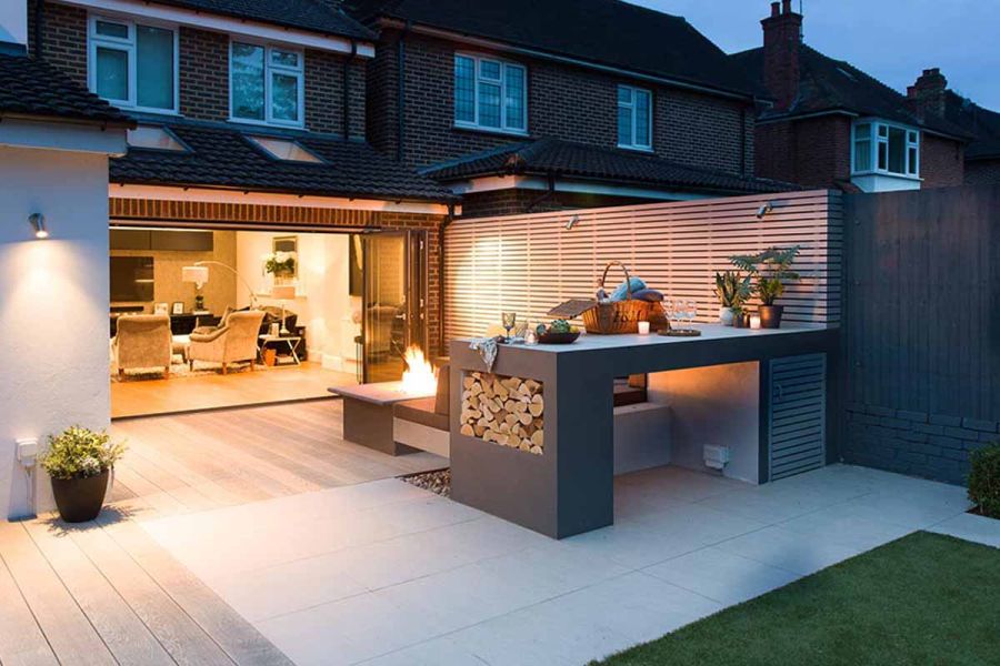 Outdoor kitchen, bench and firepit on Urban Grey Porcelain and DesignBoard composite decking, designed by Harrington Porter.